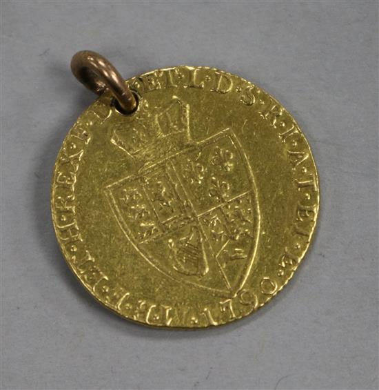A 1790 George III gold guinea (worn and drilled).
